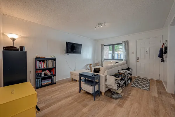 a view of a livingroom with workspace and a window