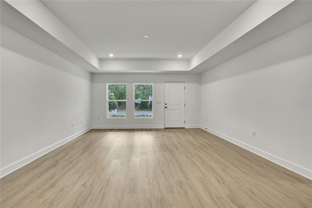 3646 Portillo Road Spring Hill, FL 34608 - Photo 3 of 16 wooden floor in an empty room with a window