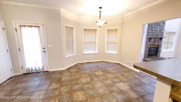 a view of kitchen with refrigerator cabinets and window
