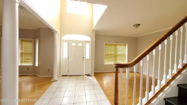 a view of an entryway with wooden floor and stairs