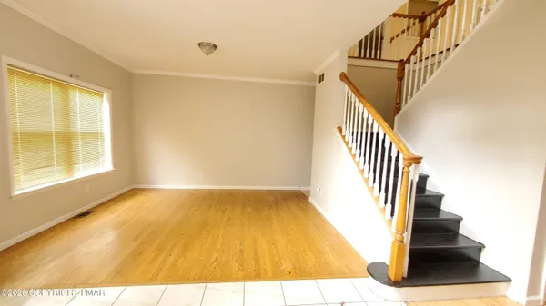 a view of an entryway with wooden floor