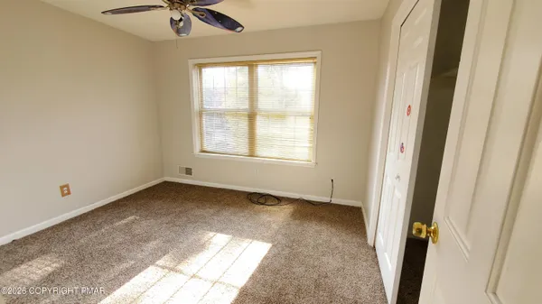 a view of an empty room and a window