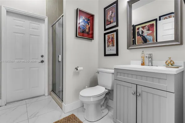 a bathroom with a toilet a sink and a mirror