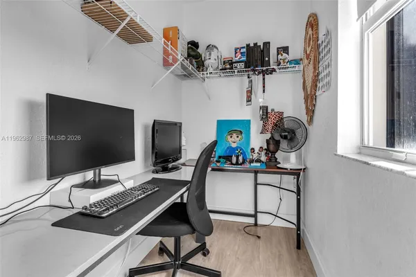 a work room with furniture and a flat screen tv