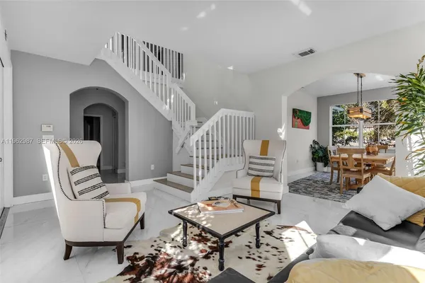 a living room with furniture and a potted plant