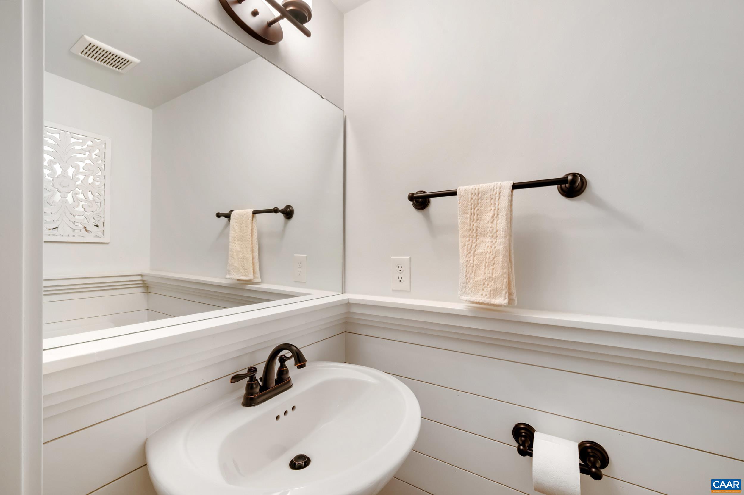 1411 Terrace Lane Charlottesville, VA 22911 - Photo 29 of 72 a bathroom with a sink and mirror with bathtub