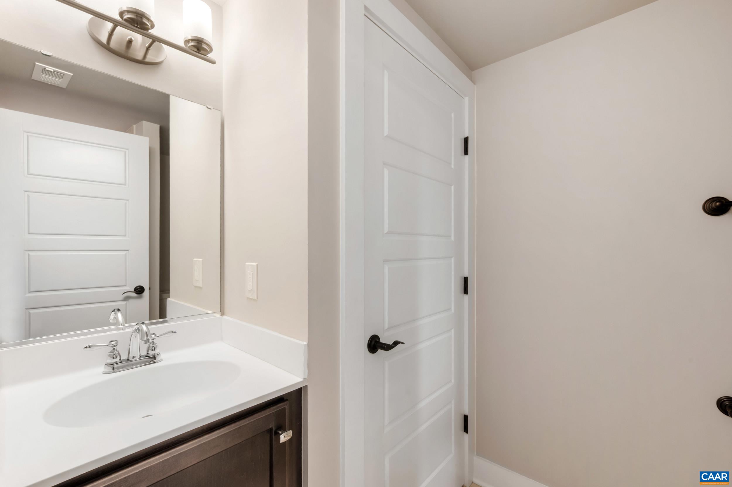 1411 Terrace Lane Charlottesville, VA 22911 - Photo 35 of 72 a bathroom with a sink and a mirror