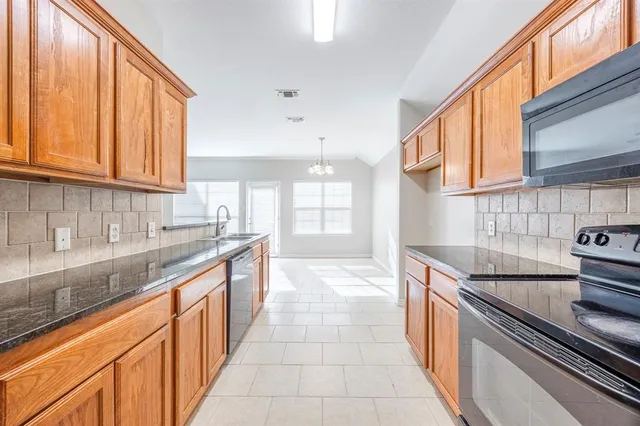 a kitchen with stainless steel appliances granite countertop a sink and cabinets