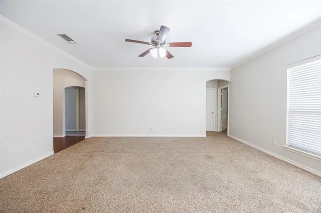 a view of a livingroom with a ceiling fan and window