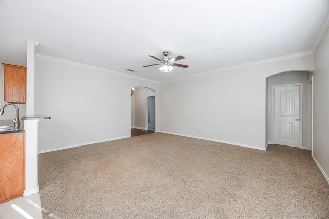a view of an empty room with a ceiling fan