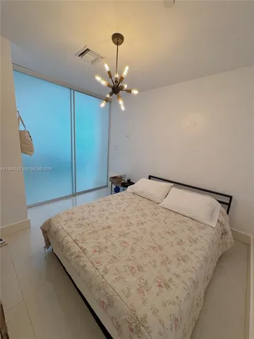 a bedroom with a bed and a ceiling fan
