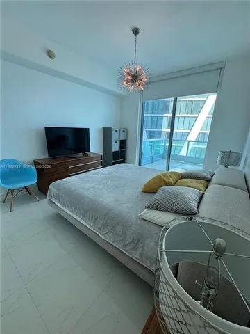 a bedroom with a bed and flat screen tv