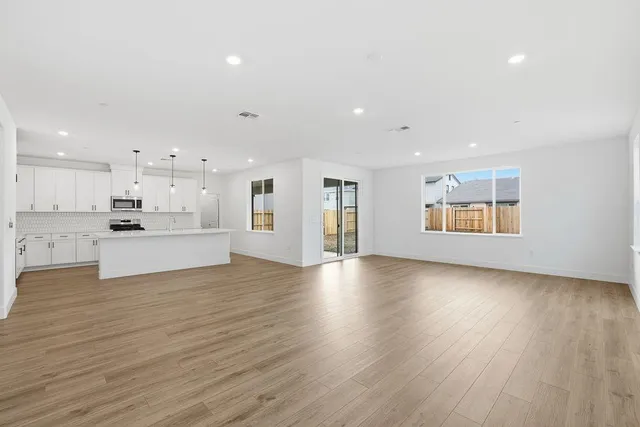 a view of kitchen and hall with wooden floor