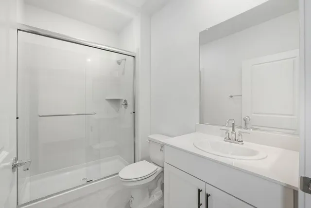 an empty room with windows and ceiling fan