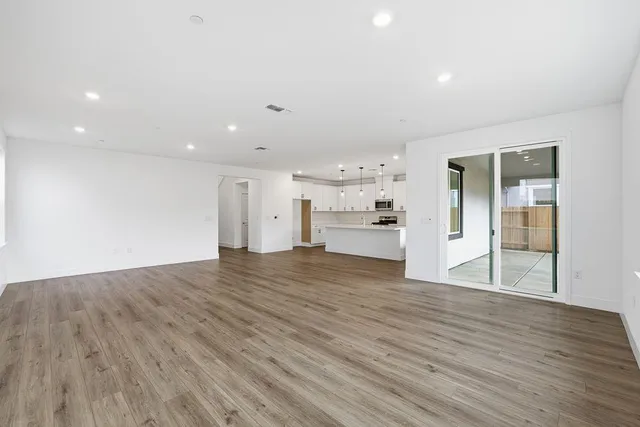 a bathroom with a granite countertop toilet a double vanity sink a mirror and a bathtub