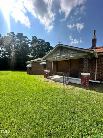 a backyard of a house with table and chairs