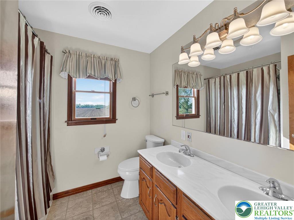7098 Limerick Square Bath, PA 18014 - Photo 21 of 31 a bathroom with a sink a toilet and a mirror