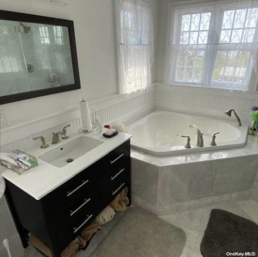 340 Surf Road Ocean Beach, NY 11770 - Photo 3 of 5 a bathroom with a sink mirror and a bathtub