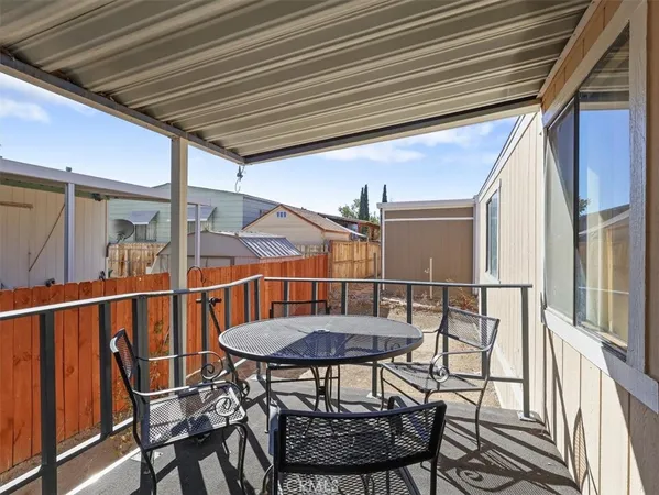 a balcony with table and chairs