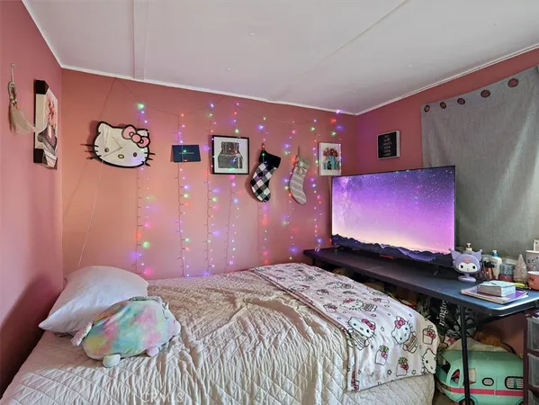 a bedroom with a bed dresser and a large mirror