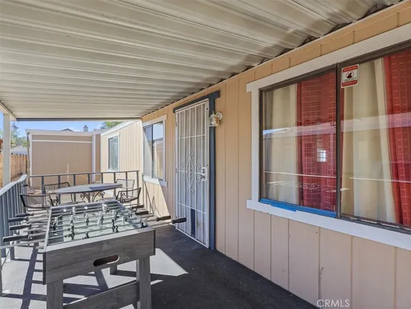 a outdoor space with a large window and furniture