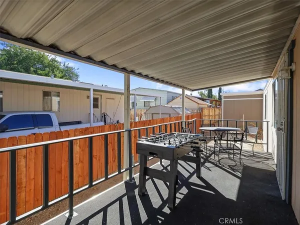 a view of balcony with wooden floor and outdoor seating