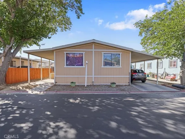 a front view of a house with a road