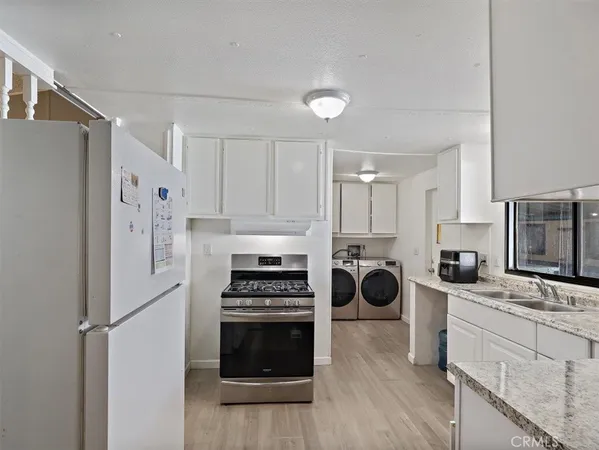 a kitchen with stainless steel appliances a refrigerator stove and sink
