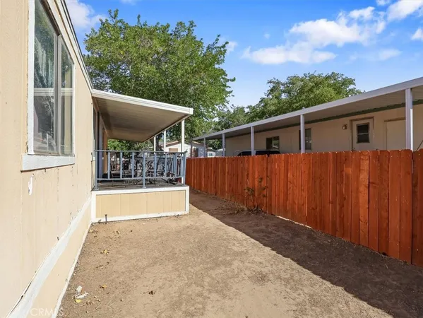 a view of a house with a backyard and balcony