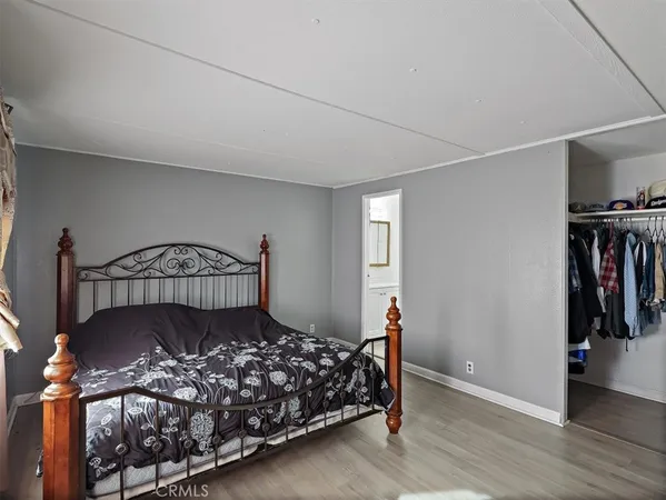 a bed sitting in a bedroom next to a window