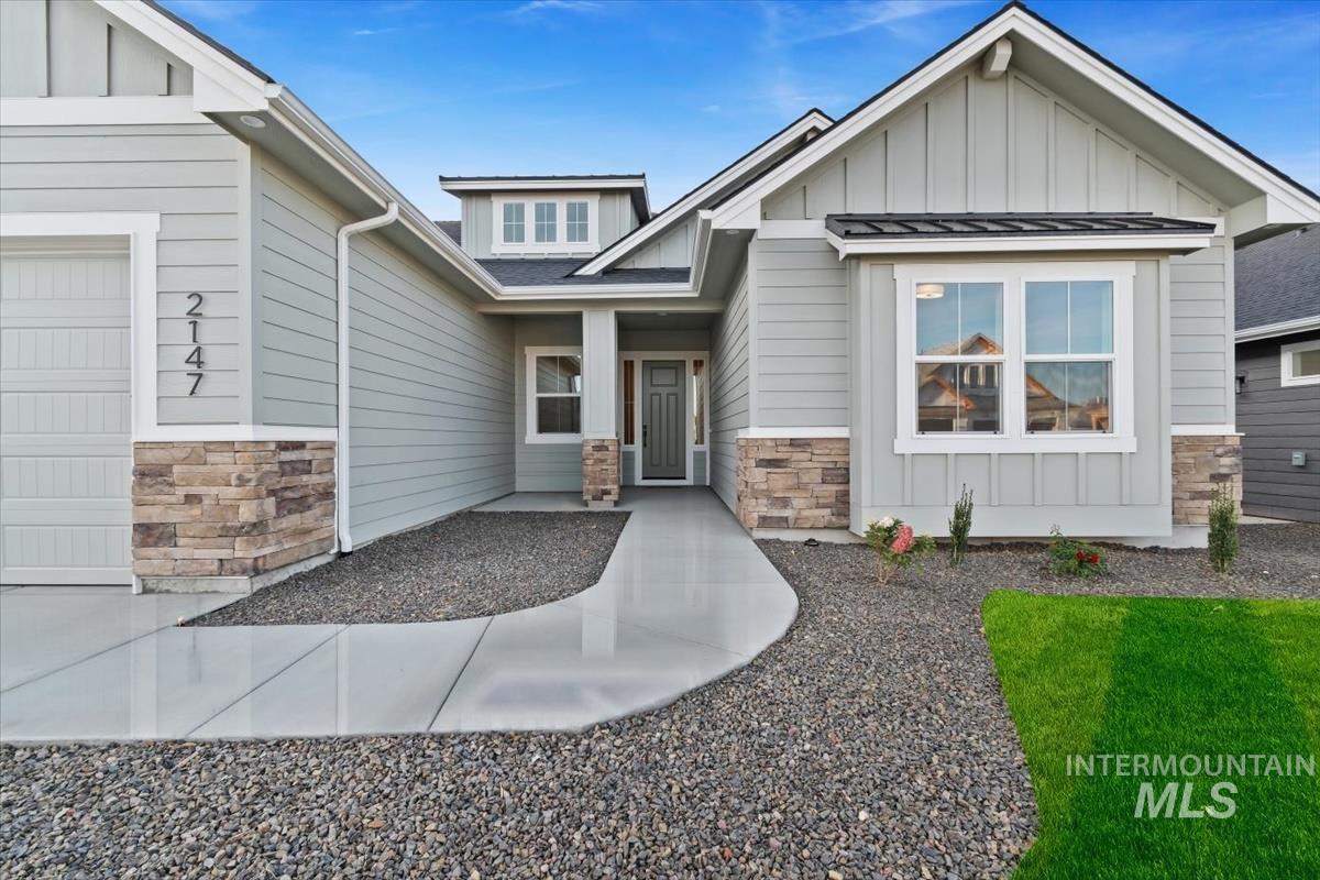 2147 East Blakehurst Avenue Kuna, ID 83634 - Photo 2 of 43 View of front of home featuring stone siding, board and batten siding, and a porch