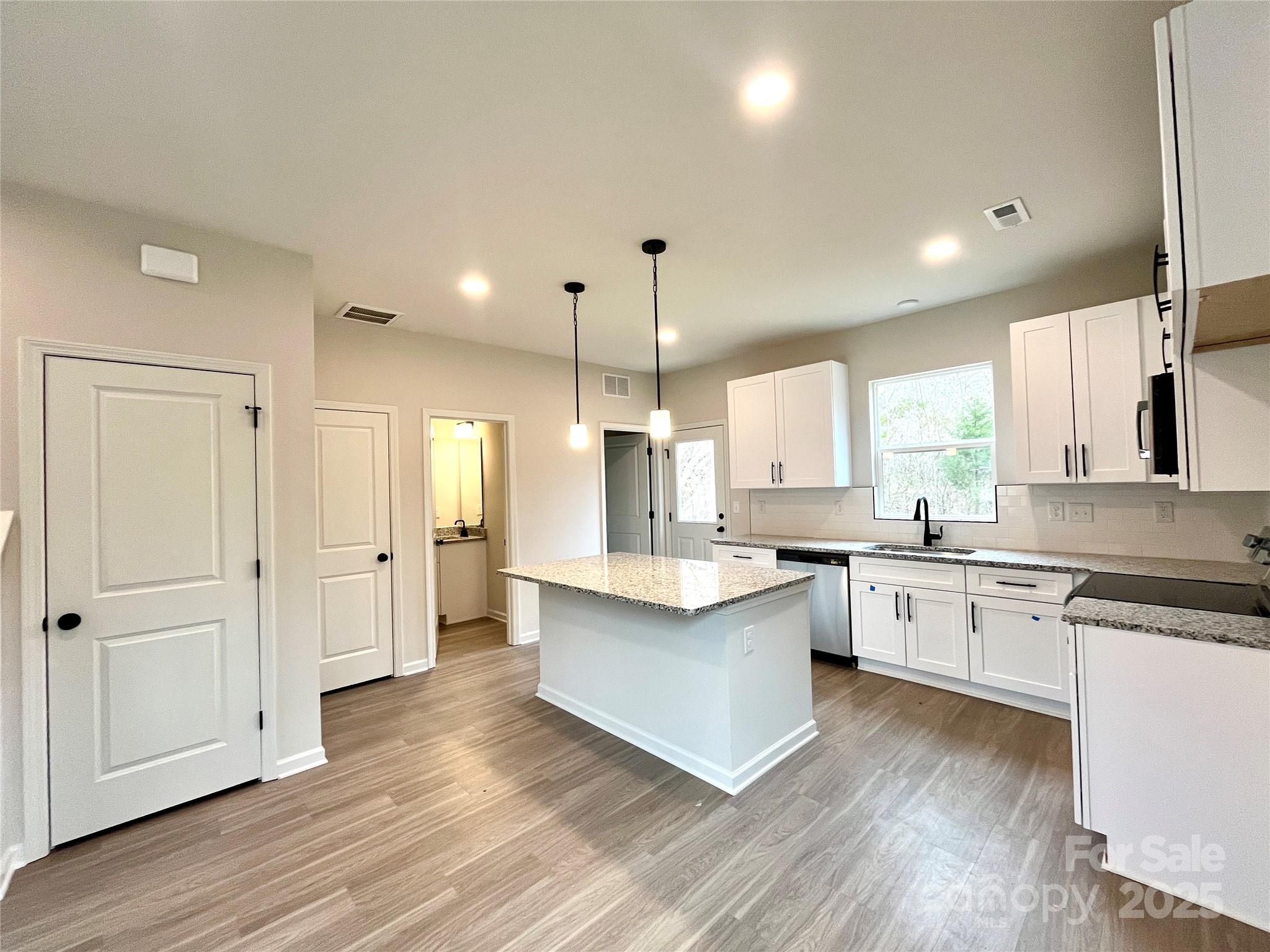 129 Sharon Road York, SC 29745 - Photo 8 of 21 a large kitchen with granite countertop a large counter top a sink stainless steel appliances and cabinets