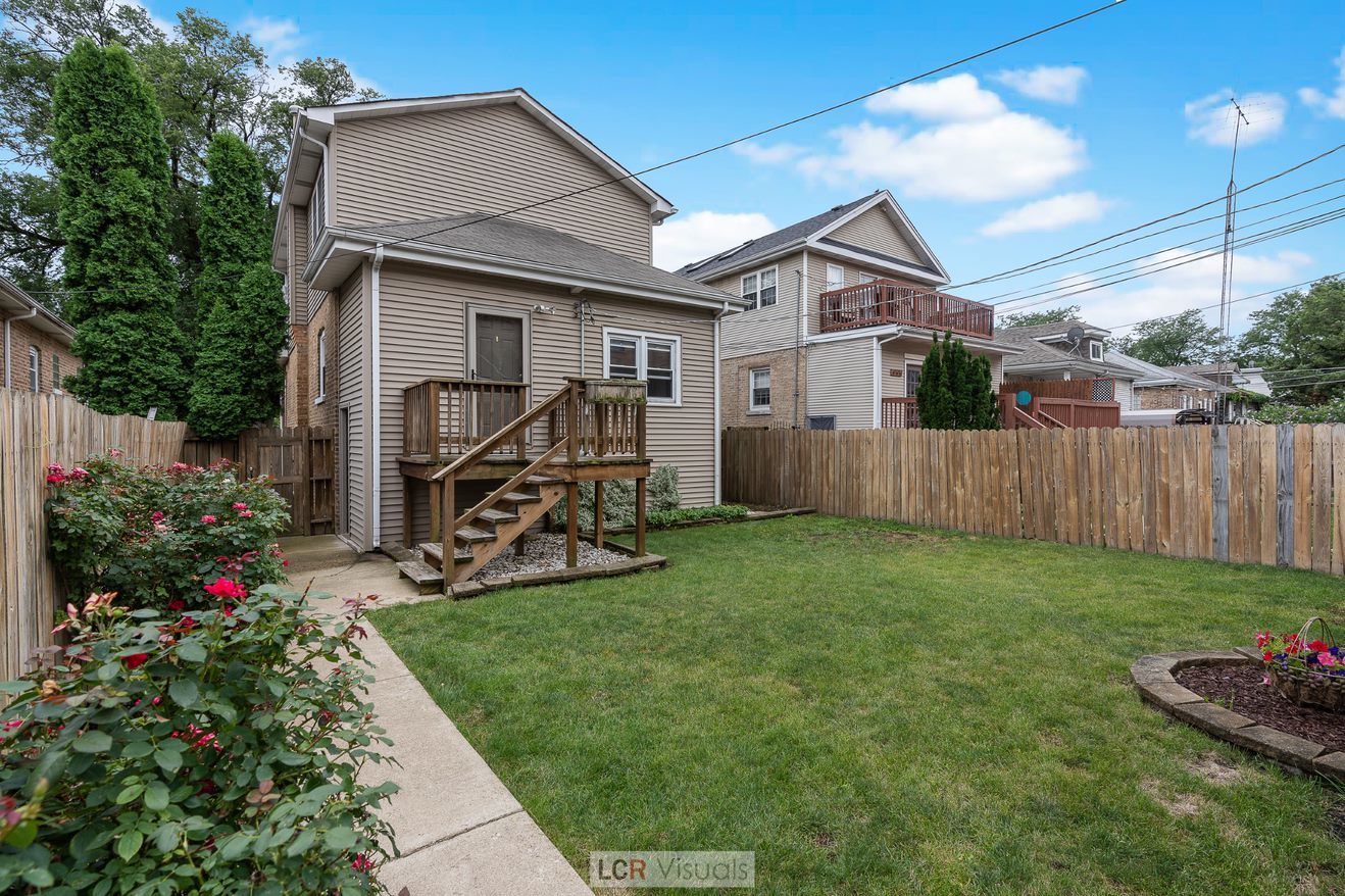 7112 West Belden Avenue Chicago, IL 60707 - Photo 16 of 19 a front view of a house with garden