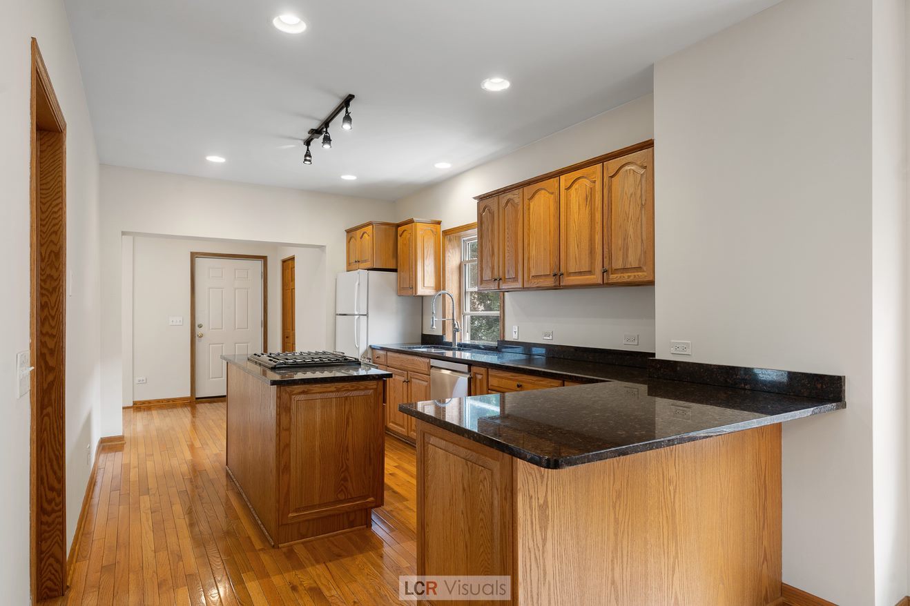 7112 West Belden Avenue Chicago, IL 60707 - Photo 4 of 19 a kitchen that has a sink and a stove in it