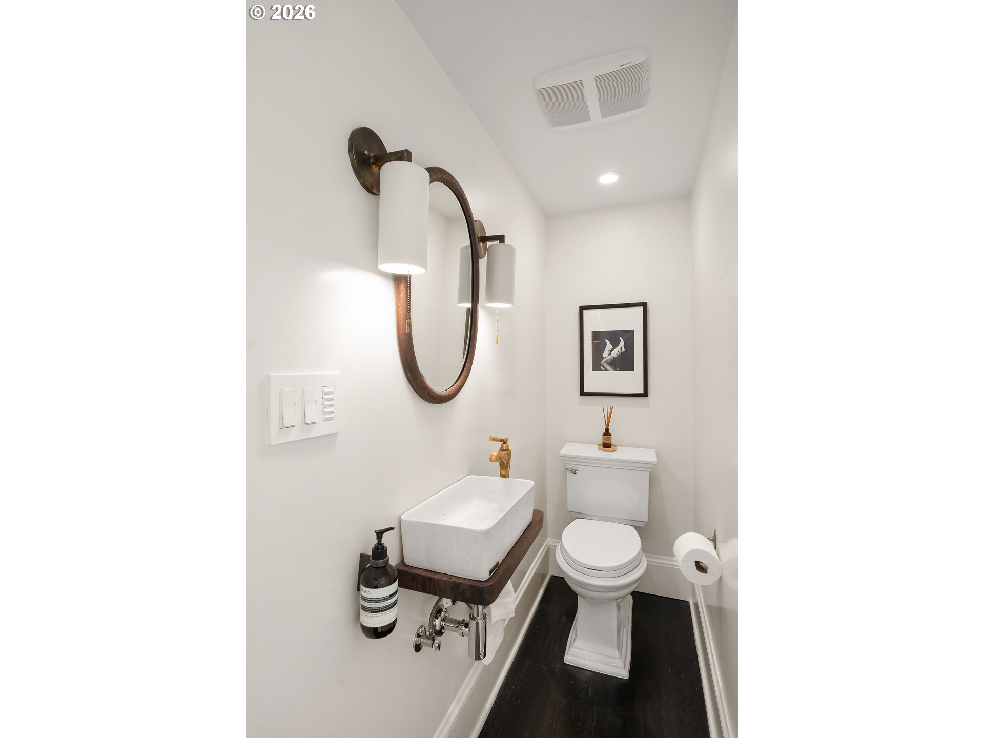 840 Northwest Summit Avenue Portland, OR 97210 - Photo 14 of 48 a bathroom with a toilet a sink and a mirror
