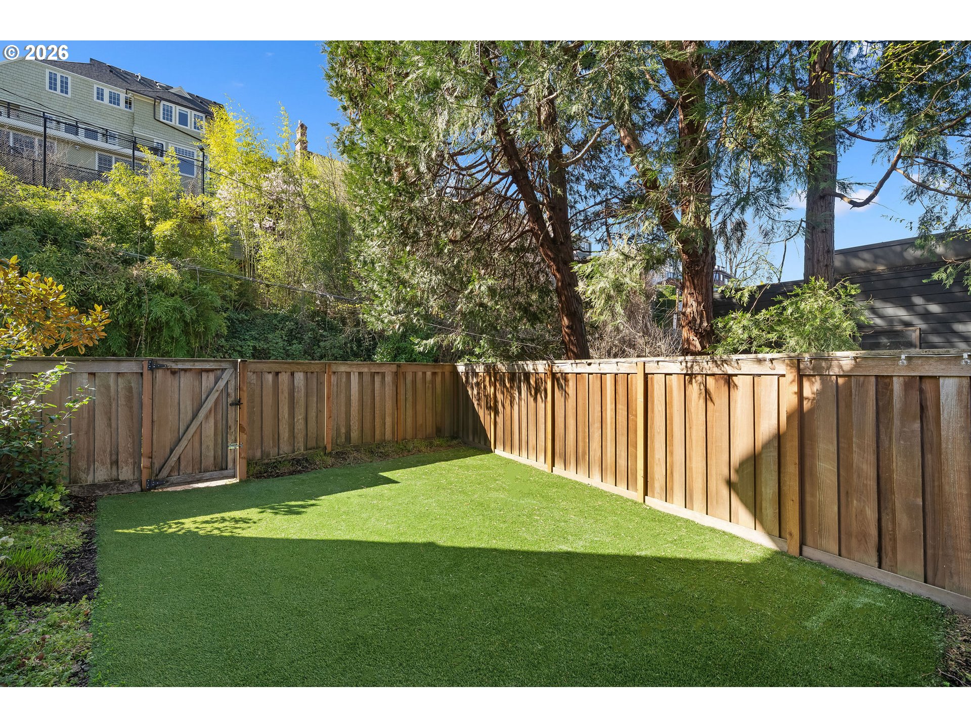 840 Northwest Summit Avenue Portland, OR 97210 - Photo 38 of 48 a view of a backyard with a fence and trees