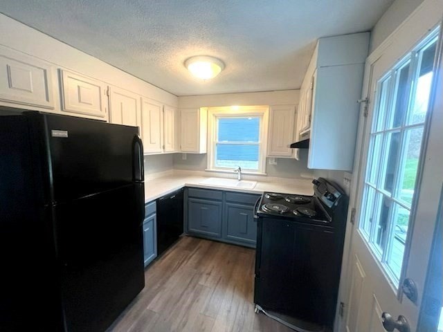 70 Chamberlain Road Westford, MA 01886 - Photo 19 of 25 a kitchen with stainless steel appliances granite countertop a refrigerator a sink dishwasher a stove and white cabinets with wooden floor