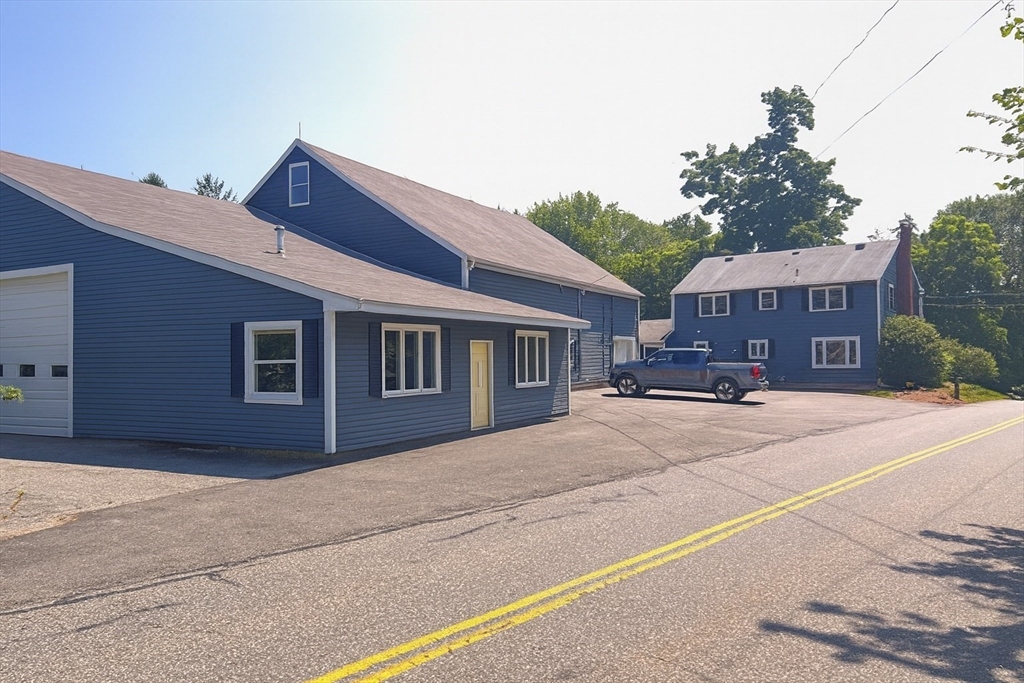 70 Chamberlain Road Westford, MA 01886 - Photo 2 of 25 a front view of a house with a yard and potted plants