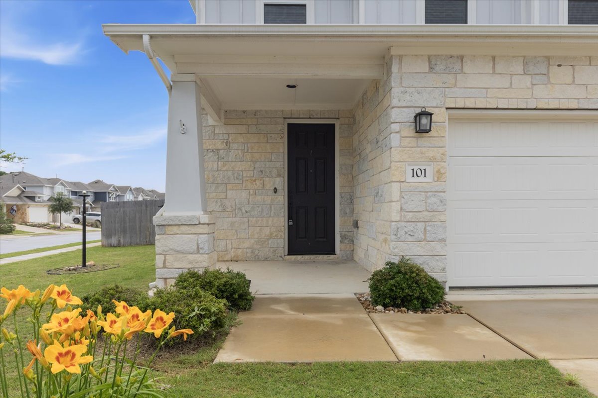 101 Free Stone Drive Georgetown, TX 78628 - Photo 2 of 40 Stone veneer facade featuring a covered entry and an attached garage