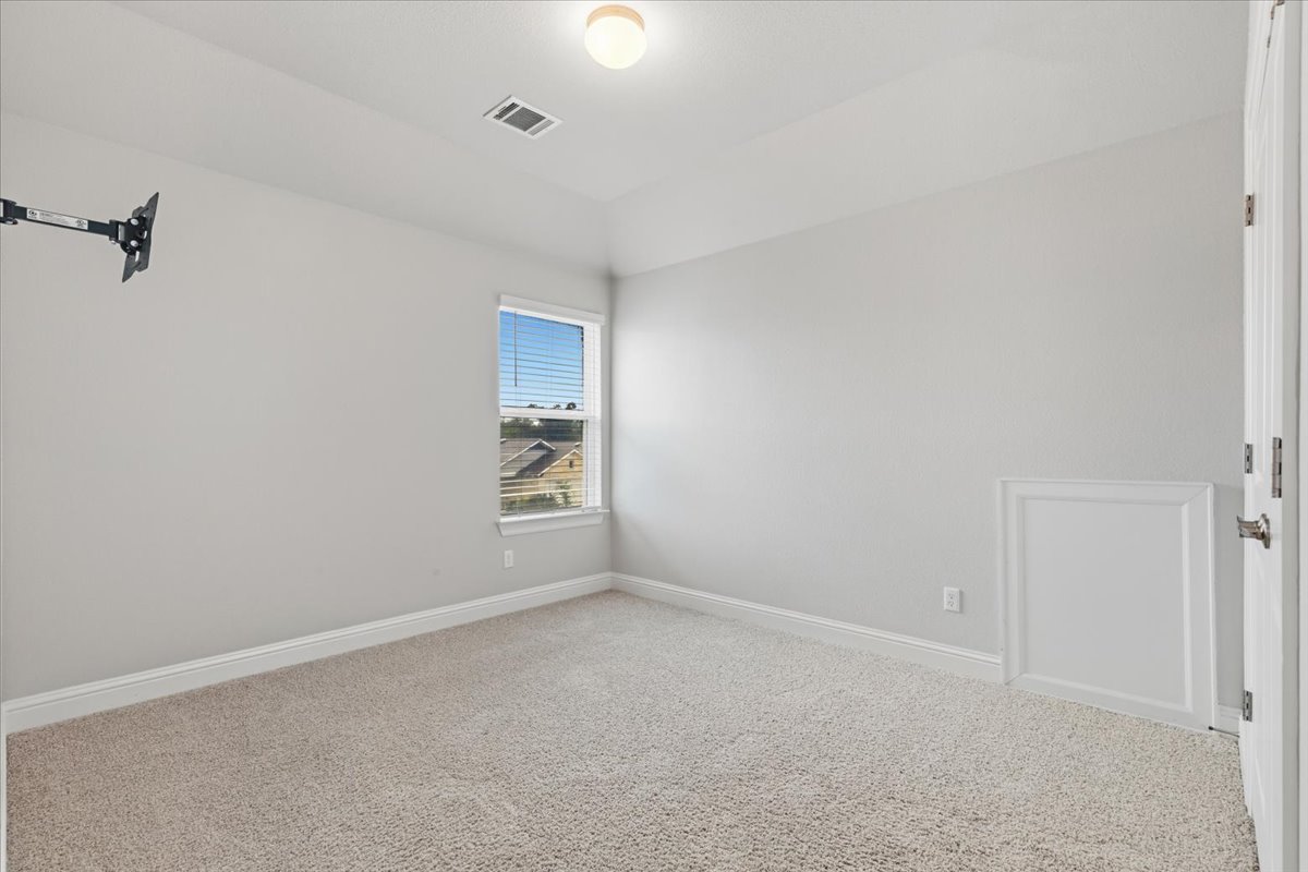 101 Free Stone Drive Georgetown, TX 78628 - Photo 23 of 40 Bright room featuring light-toned carpeting, a window with blinds, and light gray wall paint