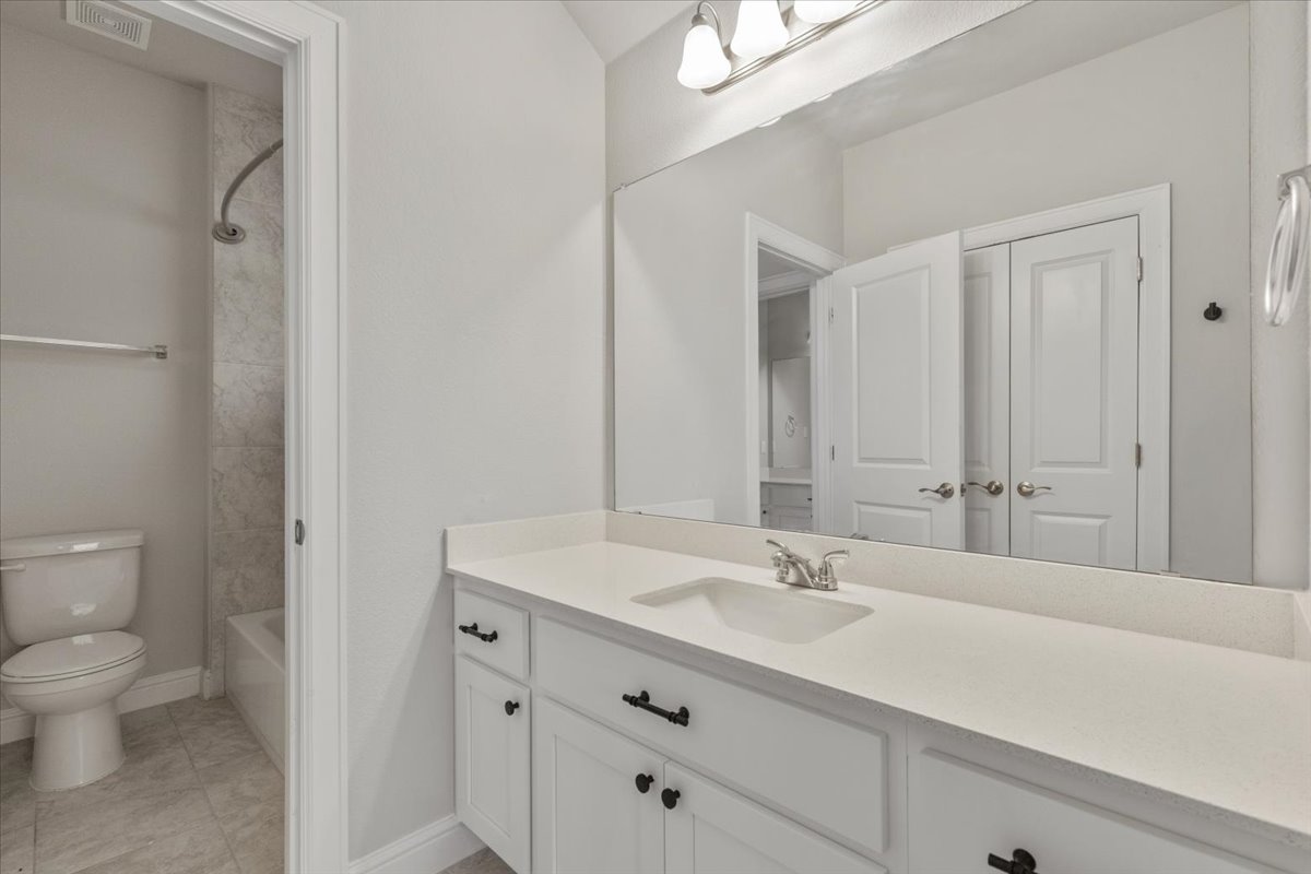 101 Free Stone Drive Georgetown, TX 78628 - Photo 28 of 40 Bathroom featuring a white vanity with an integrated sink, brushed nickel faucet, and a spacious mirror
