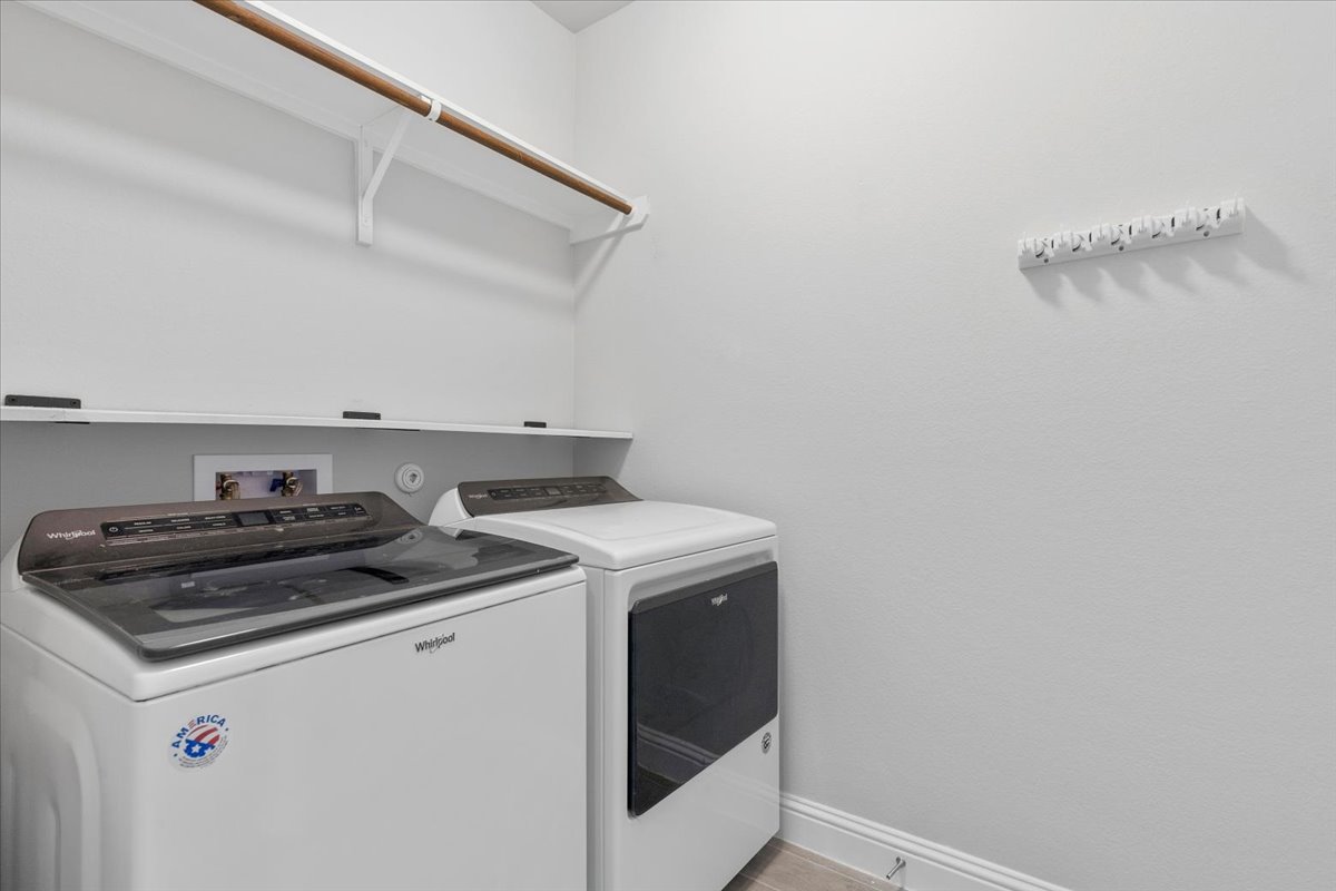 101 Free Stone Drive Georgetown, TX 78628 - Photo 32 of 40 Dedicated laundry area featuring white walls, a built-in hanging rod, and a utility shelf