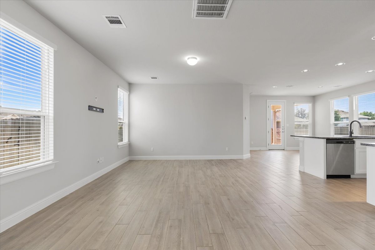 101 Free Stone Drive Georgetown, TX 78628 - Photo 9 of 40 Spacious open-concept living area featuring wood-finish flooring, recessed lighting, and ample natural light from multiple windows