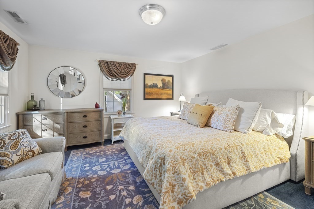 3 Benjamin Road Lexington, MA 02421 - Photo 21 of 42 a large bedroom with a bed and a lamp on dresser