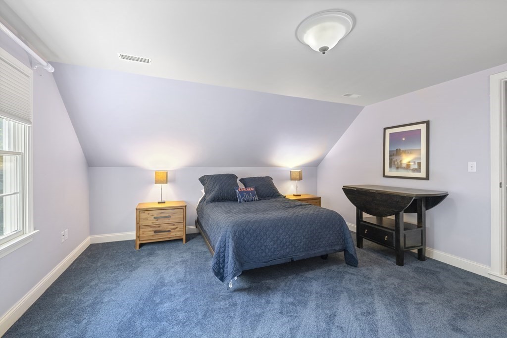 3 Benjamin Road Lexington, MA 02421 - Photo 28 of 42 a bedroom with bed and a table