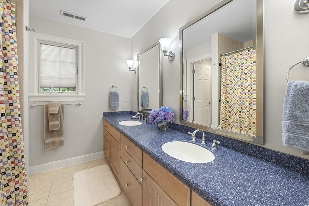 3 Benjamin Road Lexington, MA 02421 - Photo 34 of 42 a bathroom with a granite countertop double vanity sink and a mirror