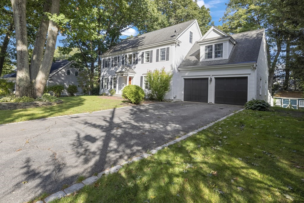 3 Benjamin Road Lexington, MA 02421 - Photo 37 of 42 a front view of a house with a yard and garage