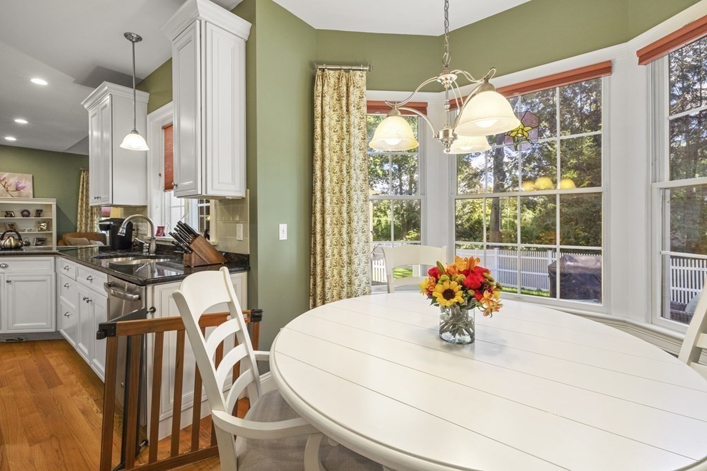 3 Benjamin Road Lexington, MA 02421 - Photo 6 of 42 a view of a dining room with furniture a chandelier and wooden floor