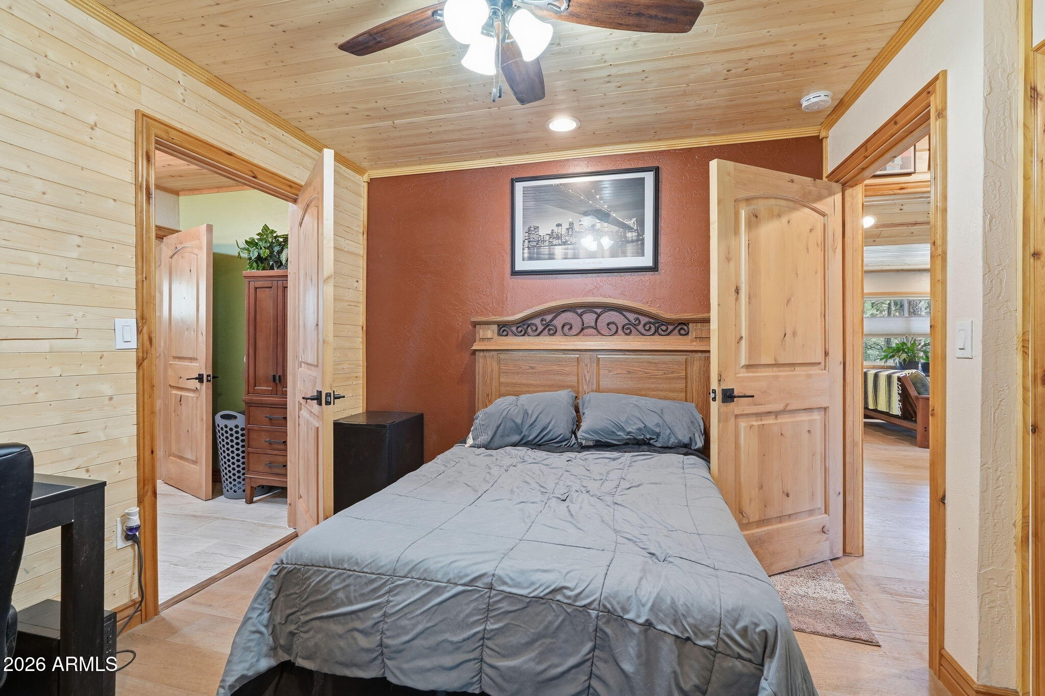 2060 Gilbert Lane Overgaard, AZ 85933 - Photo 43 of 87 a bedroom with a bed and a chandelier