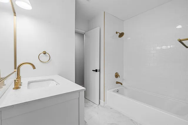 a bathroom with a sink a tub and a shower